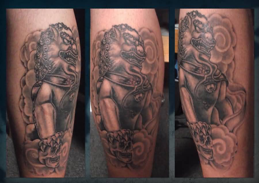 Grey Ink Skull And Foo Dog Tattoo On Leg