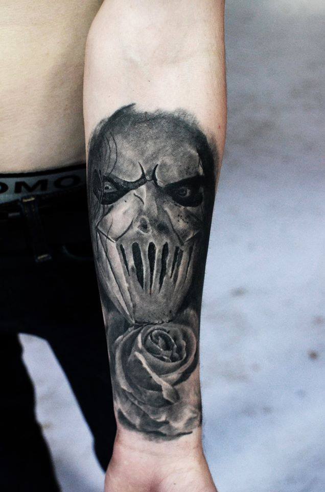 Grey Ink Slipknot Member With Rose Tattoo On Forearm