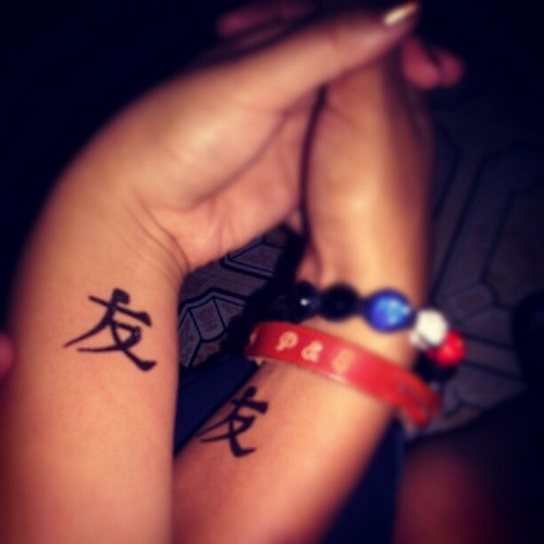 Language Symbol Matching Couple Tattoos On Wrists