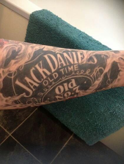 Large Jack Daniel Bottle Label Tattoo On Bicep
