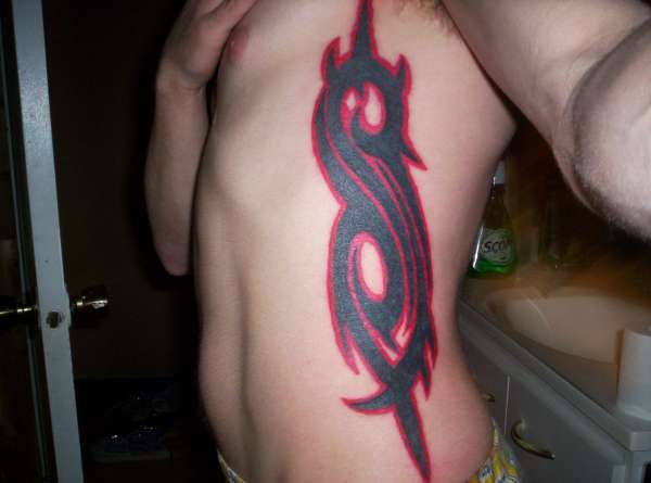 Large Slipknot Tribal Logo Tattoo On Side Rib