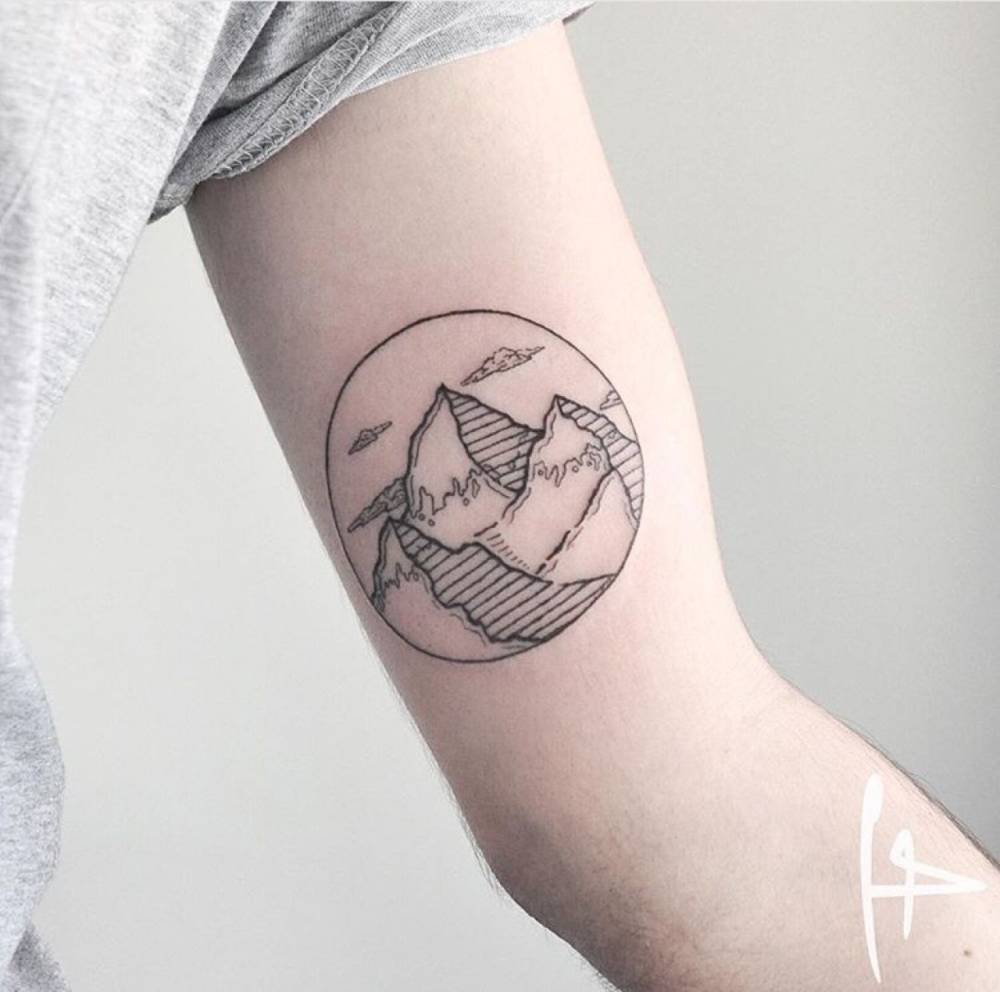 Lovely Mountains Inside Circle Tattoo On Bicep
