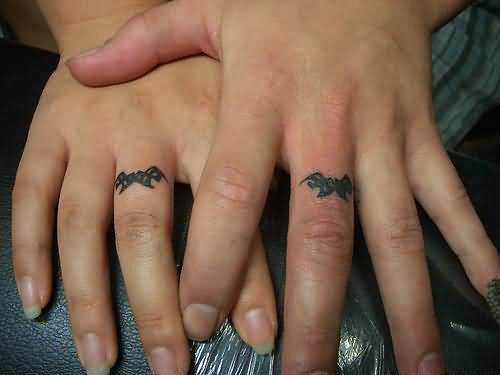 Matching Tribal Design Couple Tattoos On Fingers
