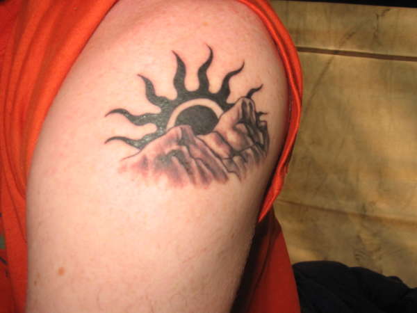 Mountains And Black Color Sun Tattoo On Right Shoulder