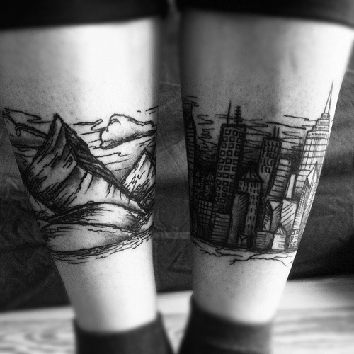Mountains And City Tattoos On Both Back Legs