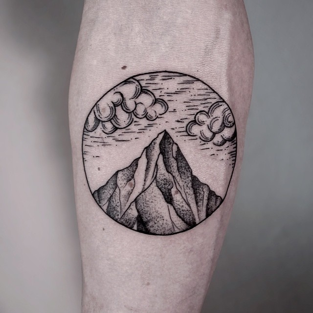 Mountains And Clouds In Circle Tattoo On Forearm