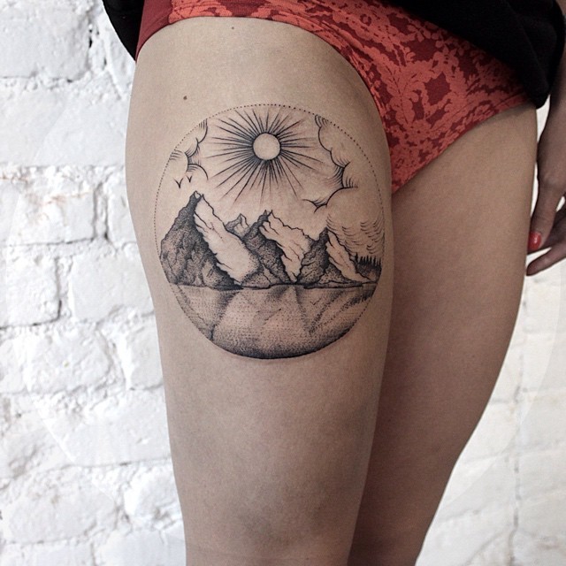 Mountains And Sun With Clouds In Circle Tattoo On Thigh