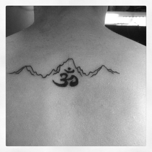 Mountains Range Line With Om Word Tattoo On Upper Back