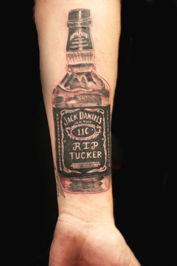 Nice Black And Grey Jack Daniels Bottle Tattoo On Wrist