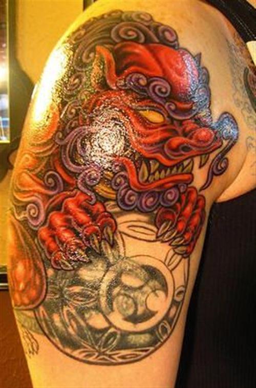 Nice Japanese Foo Dog Holding Shield Tattoo On Right Shoulder