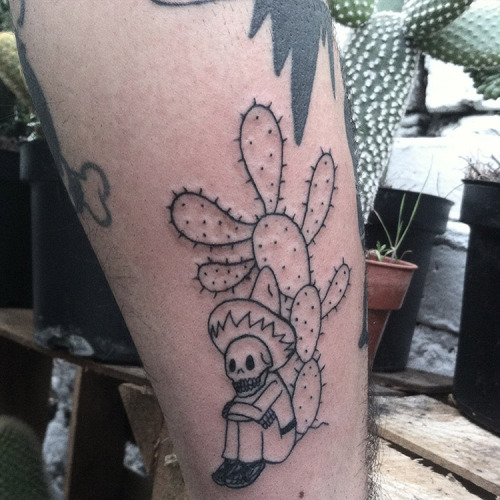 Nice Skeleton Sitting With Prickly Pear Tattoo