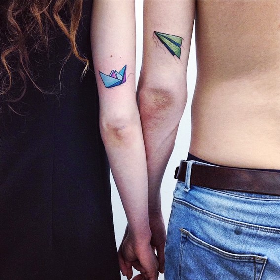 Paper Made Plane And Boat Matching Couple Tattoo On Triceps