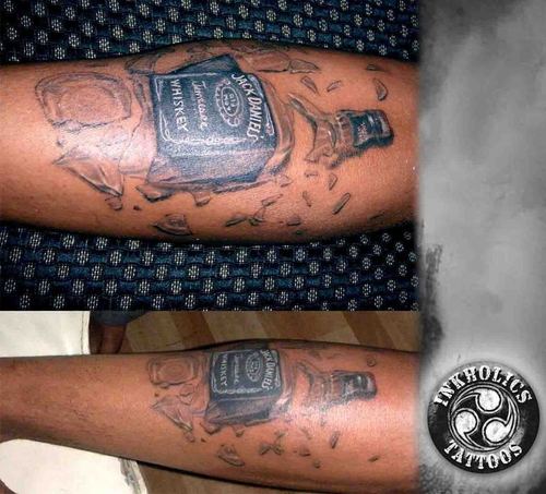 Realistic Broken Into Two Jack Daniel Bottle Tattoo