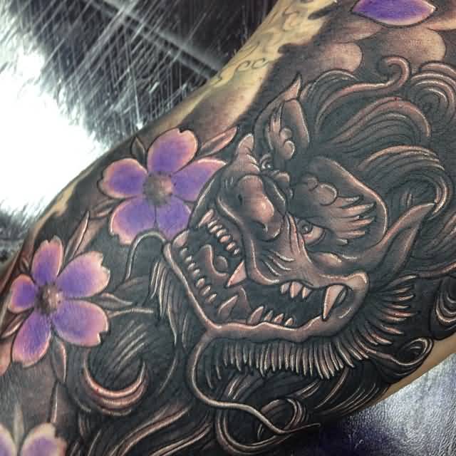 Realistic Colored Japanese Foo Dog With Purple Flowers Tattoo By Craig Holmes