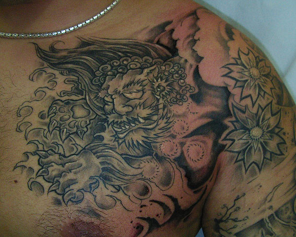 Realistic Foo Dog Ripped Skin With Flowers Tattoo On Left Chest