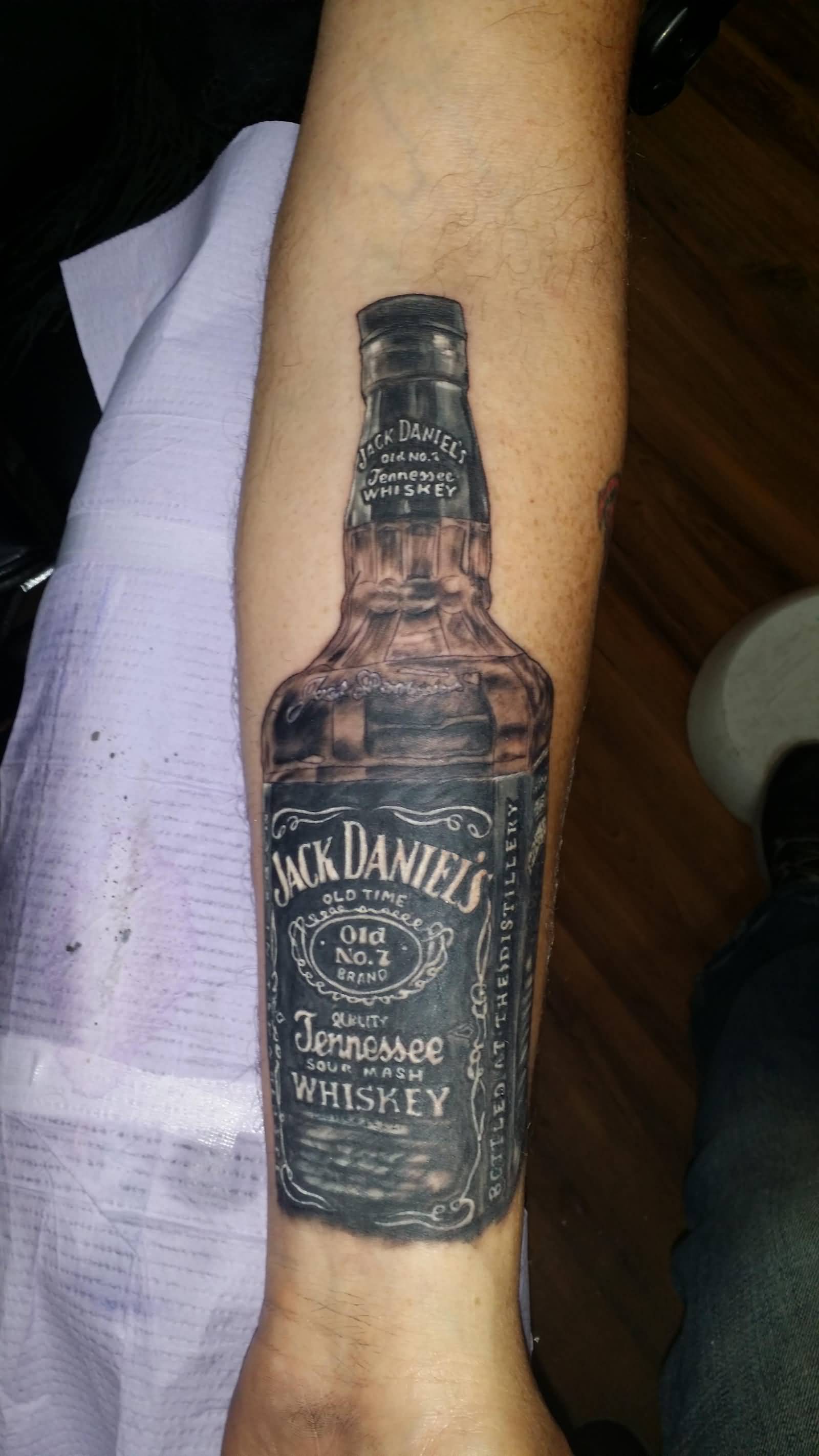 Realistic Jack Daniel Bottle Tattoo On Forearm