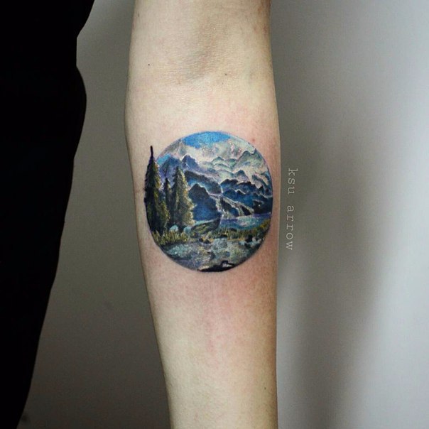 Realistic Mountains View With Trees In Circle Tattoo On Forearm