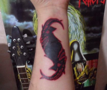 Red And Black Color Slipknot Goat Faces Tattoo On Wrist