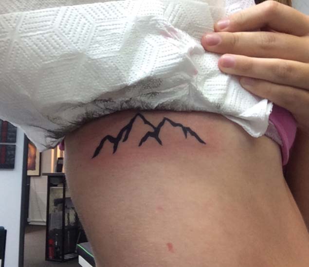Simple Black Ink Mountains Tattoo On Side Rib