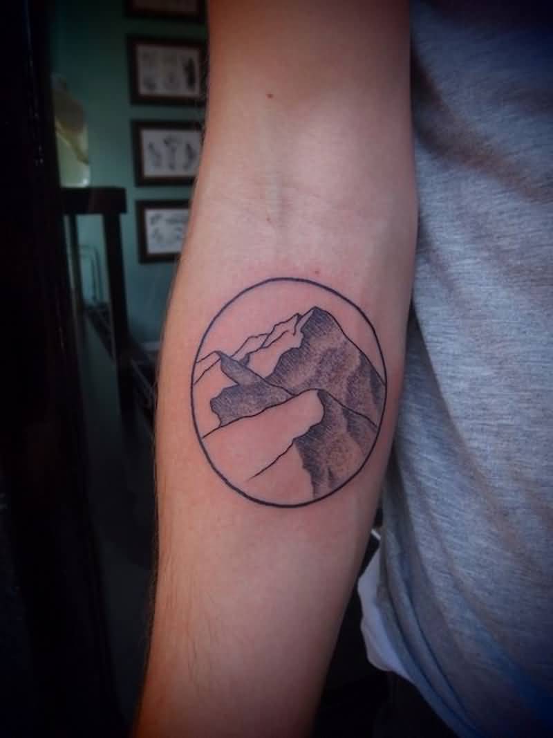 Simple Mountains In Circle Tattoo On Forearm