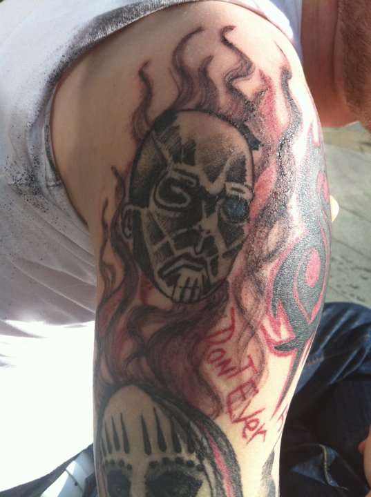 Slipknot Tribal Logo With Flames And Members Tattoo On Left Half Sleeve