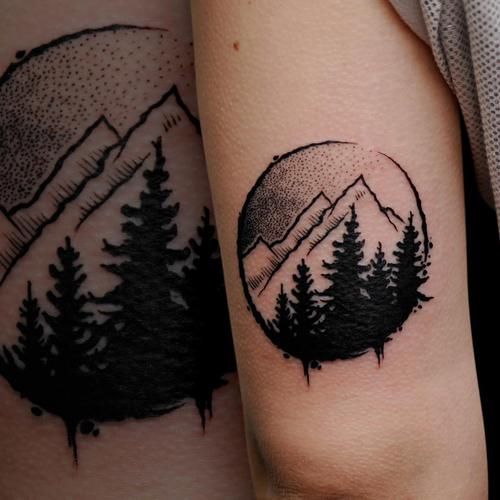 Small Black And Grey Mountains And Trees In Circle Tattoo On Triceps