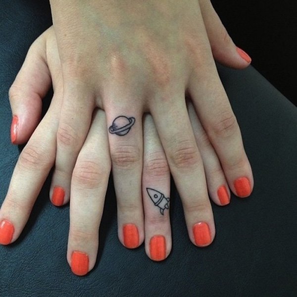 Small Planet And Rocket Matching Tattoos On Fingers