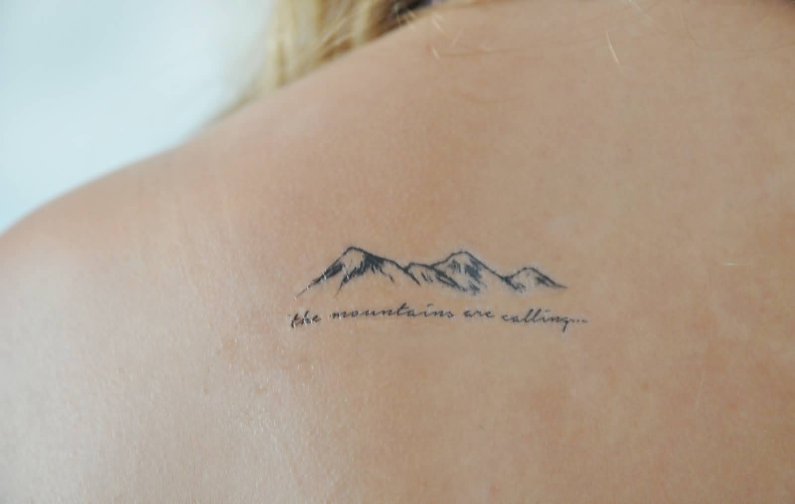 Smallest Simple Mountains With Lettering Tattoo On Upper Back