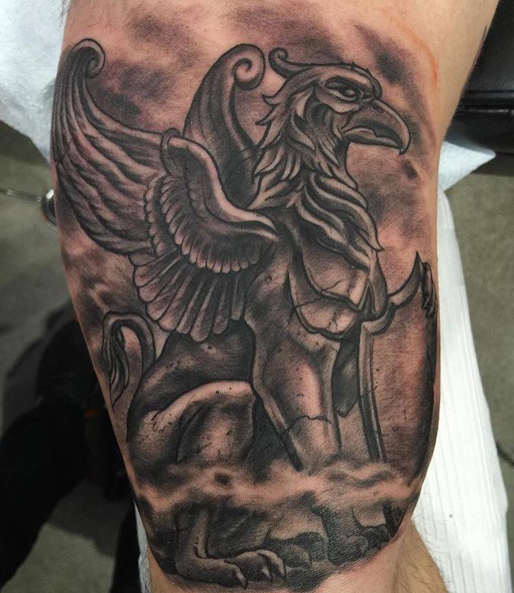 Stone Griffin Tattoo On Bicep by Joey Hamilton Tattoos