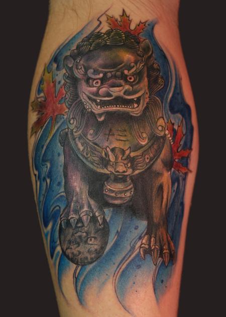 Superb Foo Dog With Blue Background Tattoo On Forearm