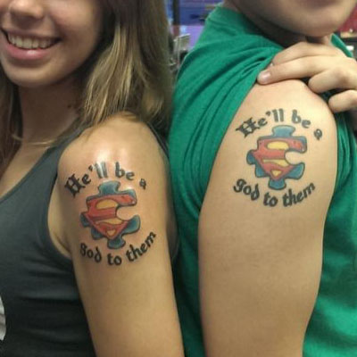 Superman Logo On Puzzle With Lettering Matching Tattoos On Shoulders