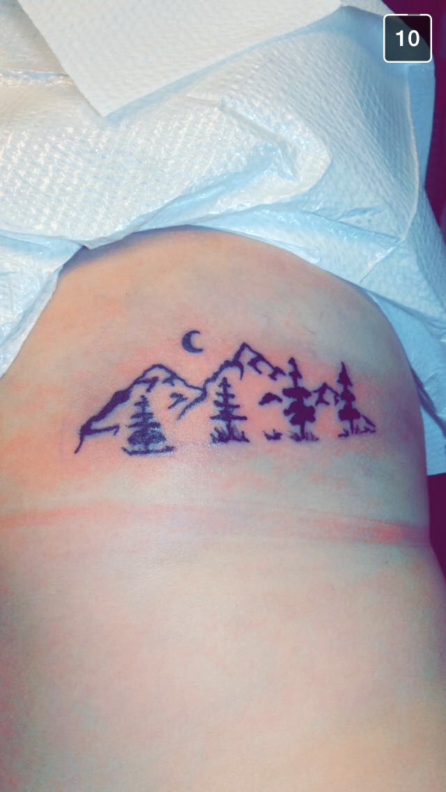 Tiny Mountains With Trees And Moon Tattoo On Rib