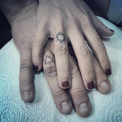 Tiny Triangle And Heart Outline Matching Tattoos On Fingers