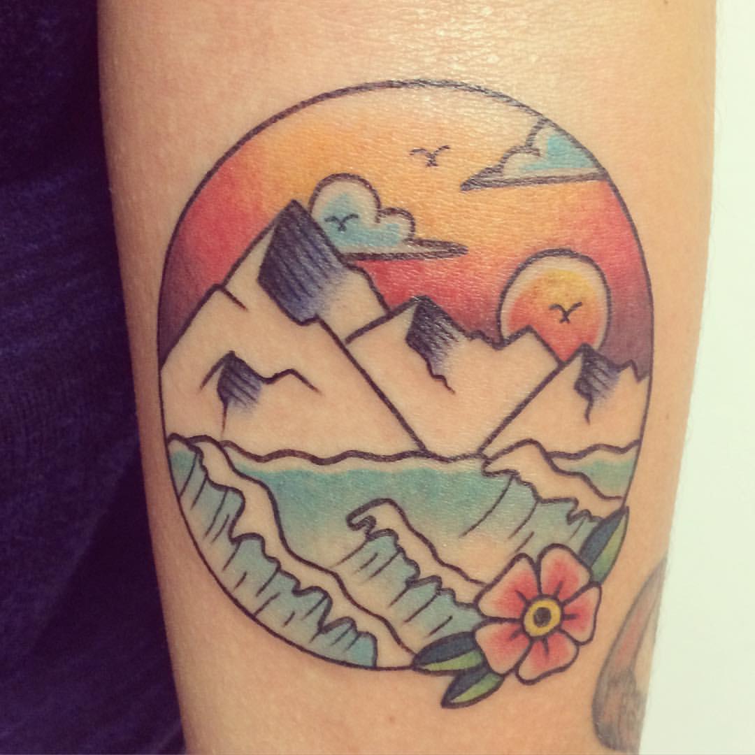 Traditional Icy Mountains And Sun In Circle Tattoo