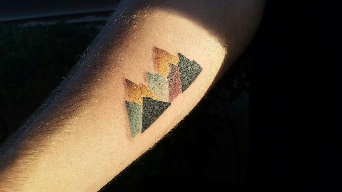 Very Nice Colorful Geometric Mountains Tattoo On Forearm