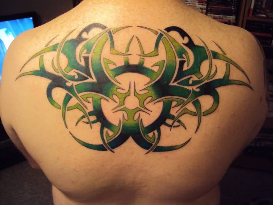 Amazing Green Tribal Biohazard Tattoo On Upper Back By MonoxideChild86