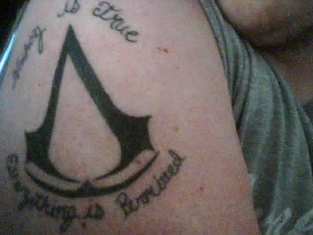 Assassins Creed Logo Tattoo On Shoulder For Men