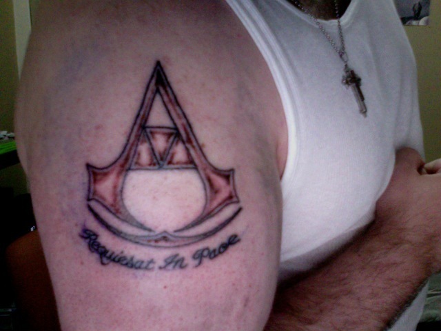 Assassins Creed Tattoo On Right Shoulder
