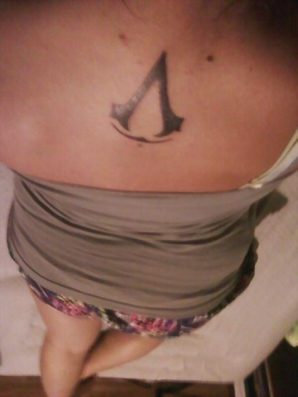Assassins Creed Tattoo On Upper Back For Girls