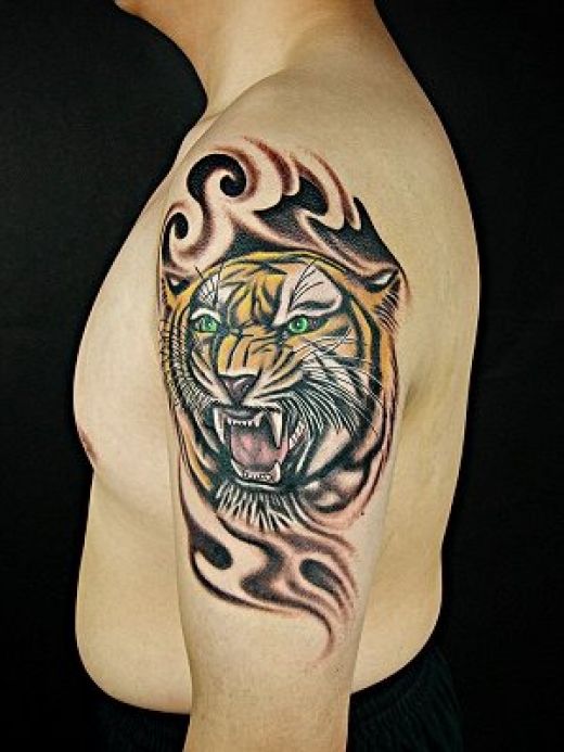 Attractive Colorful Tiger Face With Tribal Design Tattoo On Left Half Sleeve