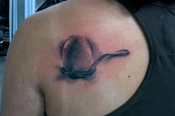 Awesome Grey Egg In Spoon Tattoo On Left Back Shoulder