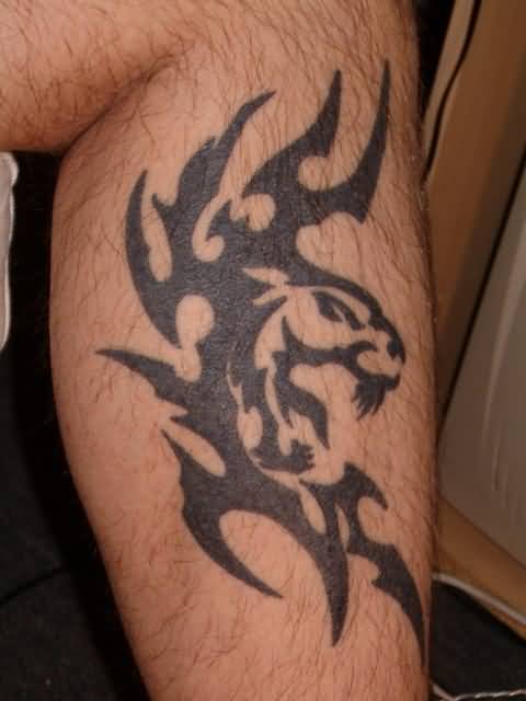 Awesome Roaring Tribal Panther Head With Design Tattoo On Leg