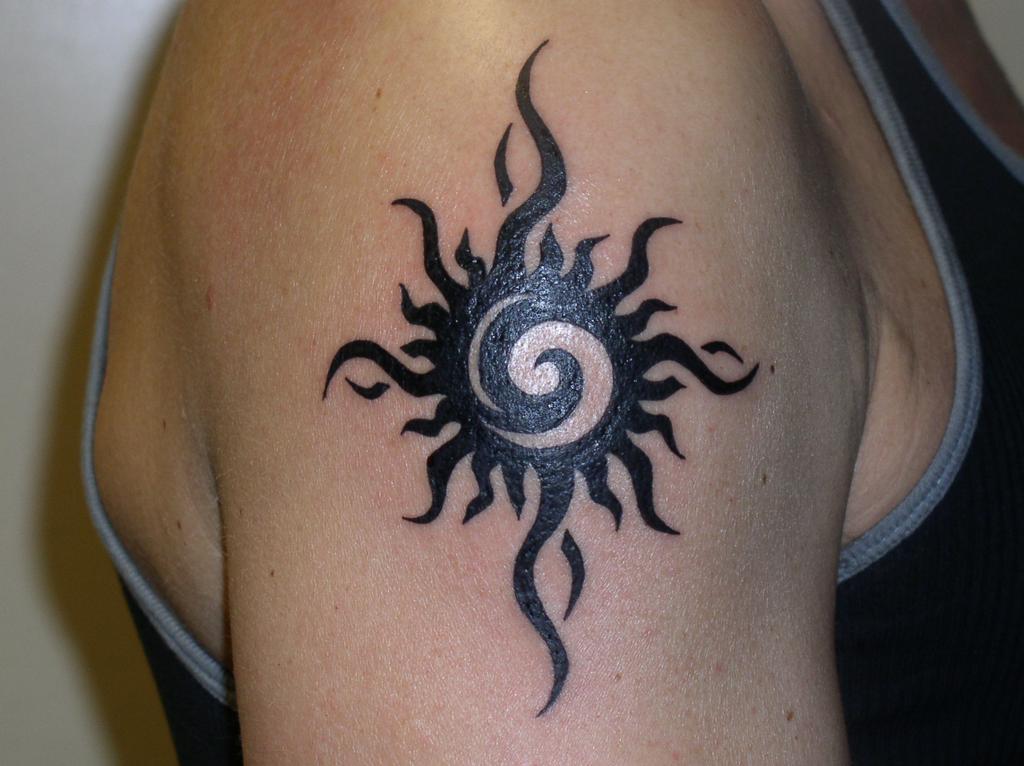 Awesome Small Black Tribal Sun Tattoo On Right Shoulder