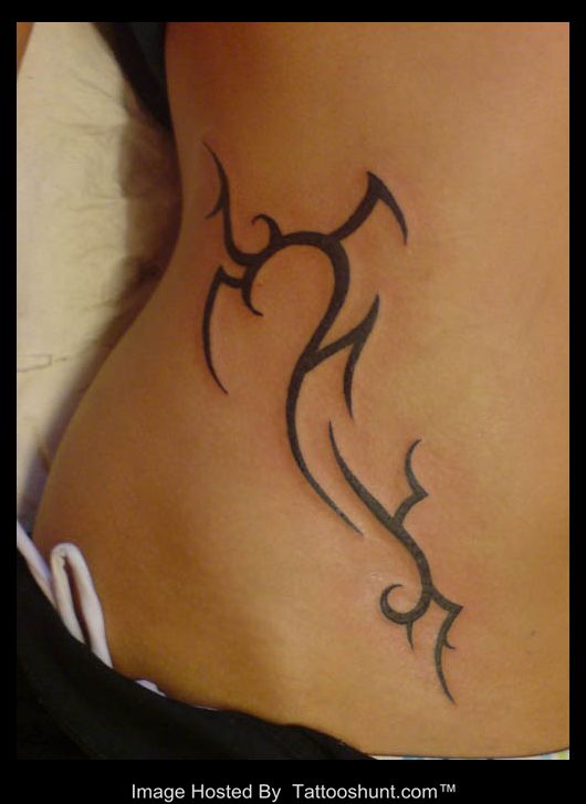 Awesome Tribal Design Tattoo On Right Hip