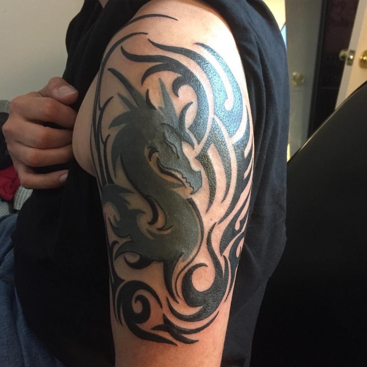 Beautiful Black Dragon With Tribal Design Tattoo On Left Half Sleeve