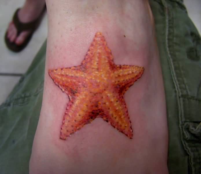 Beautiful Orange Color Starfish Tattoo On Wrist
