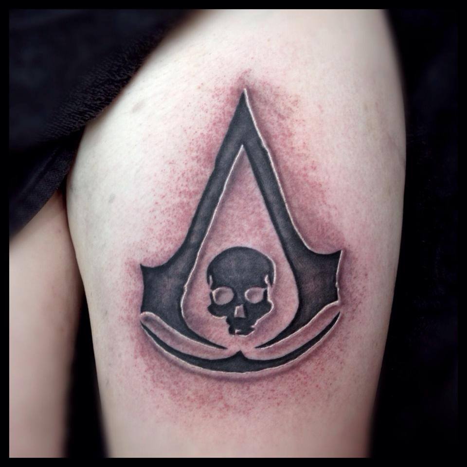Black And Grey Assassins Creed Tattoo On Thigh by Paul Priestley