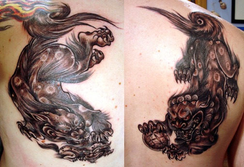 Black And Grey Color Foo Dogs Statue Tattoo On Upper Back