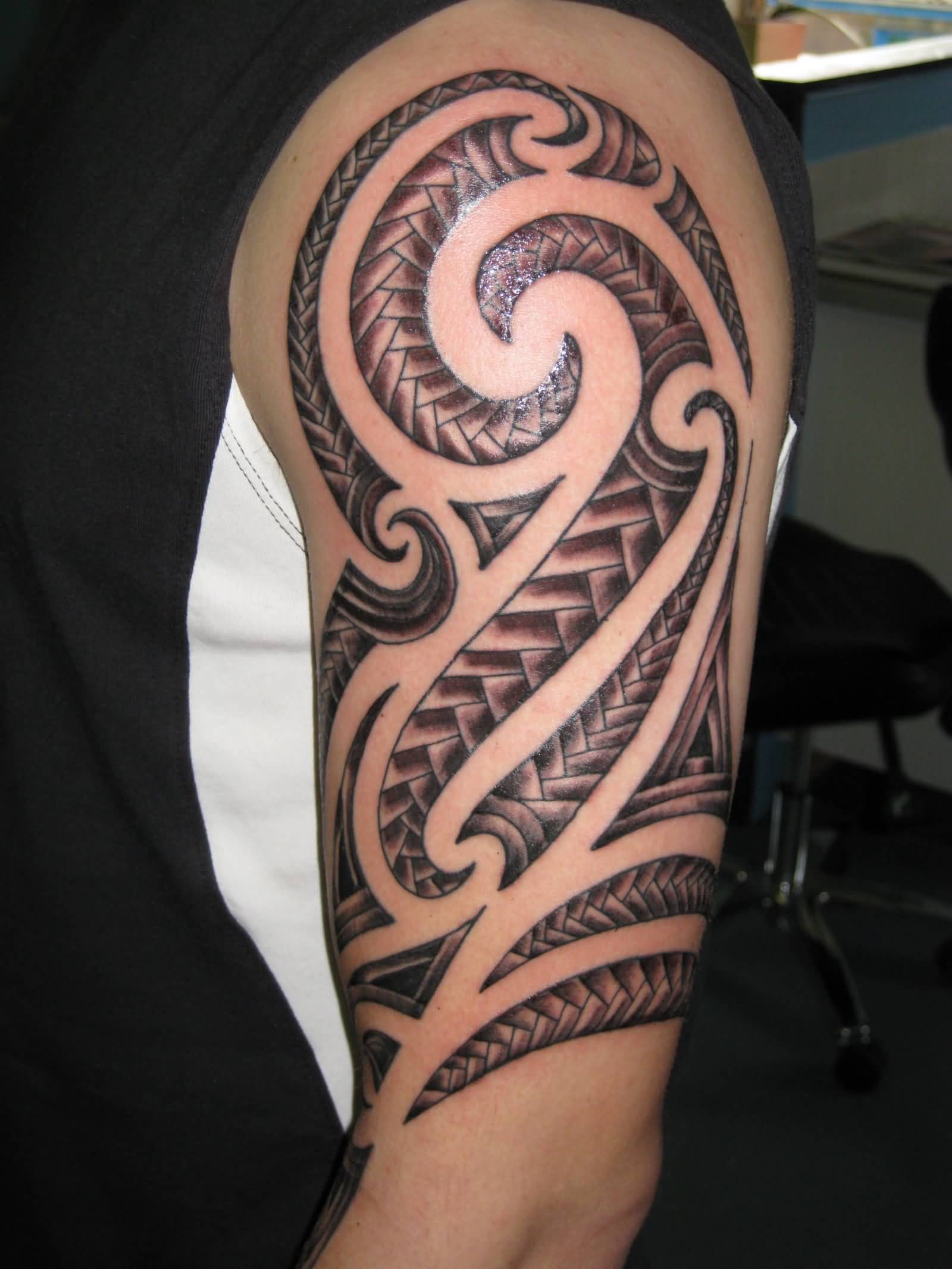 Black And Grey Maori Tribal Tattoo On Left Half Sleeve