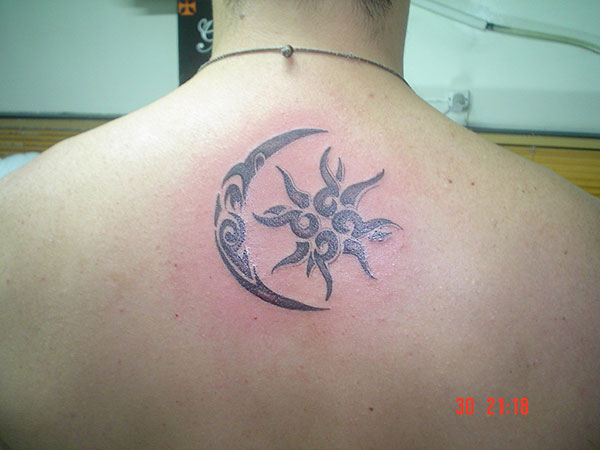 Black And Grey Small Half Moon With Sun Tattoo On Upper Back
